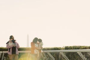 The Dorsey-Lee Family on top of the Kennedy Center with the Washington Monument in the background.